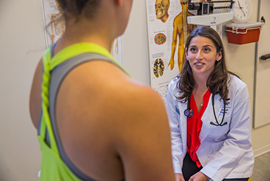 A Physician Assistant student talking to a patient