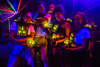 Students during laser tag at an event posing for the camera