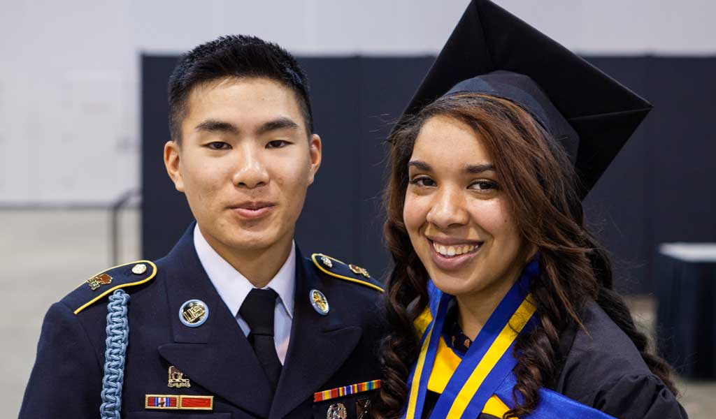 Military member and Johnson & Wales graduate posing for photo