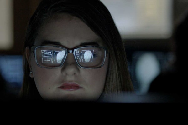 Computer screen reflected in student’s glasses.