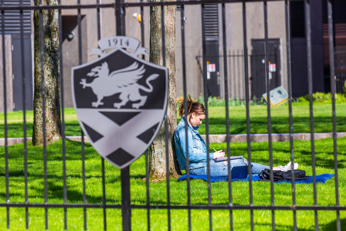 Student studying on lawn in Gaebe Commons