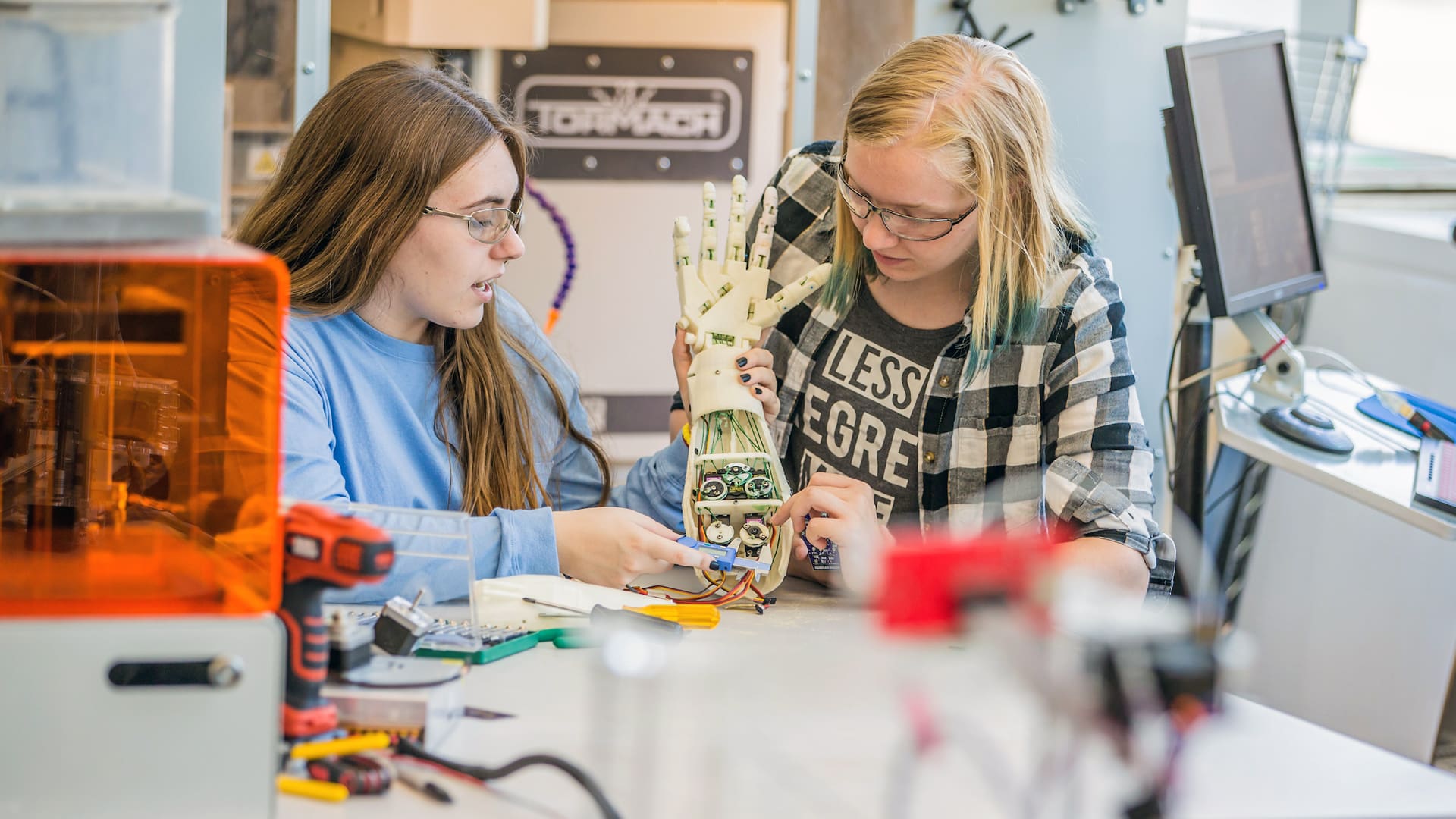 Two female students working on an engineering project.