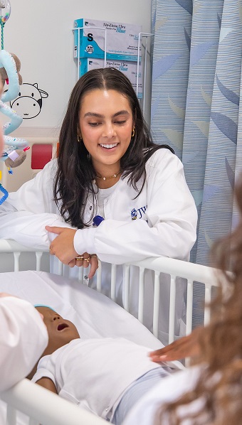 nursing student with baby simulation