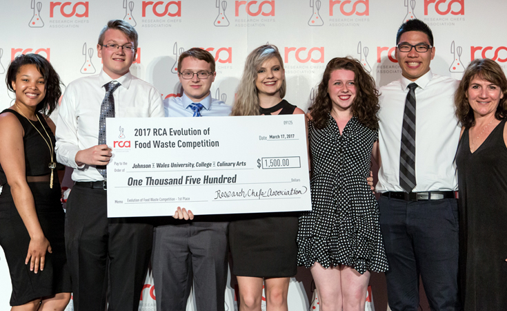 Natasha Daniels, Samuel Burgess, Ray Holloway, Jessica Pulling, Samantha Gannon, Victor Eng and team advisor Lynn Tripp with the winning check at the RCA’s Evolution of Food Waste competition. Photo: Research Chefs Association