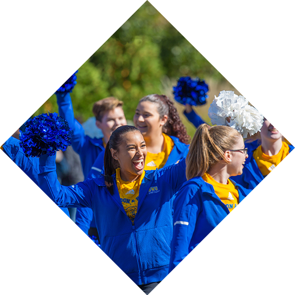 Female student with pompoms cheering