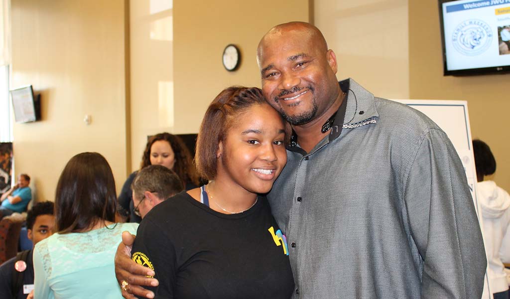 A JWU student with her father at an on-campus event.