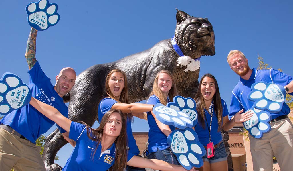 JWU students celebrate at the Wildcat statue