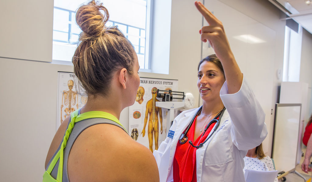 person in doctor's office with doctor