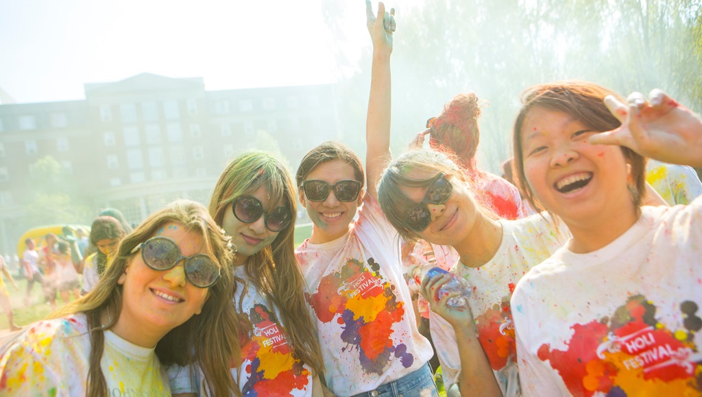 group of students celebrating the Indian festival, Holi