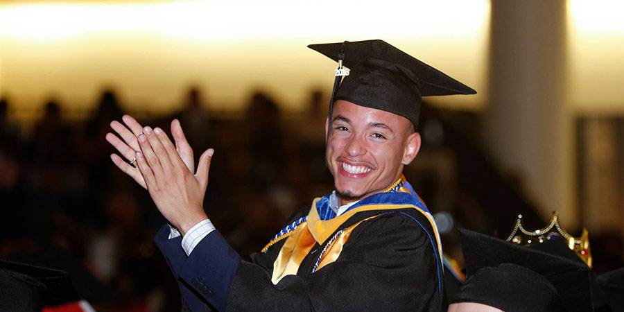 Student applauding in the crowd at JWU North Miami's Commencement