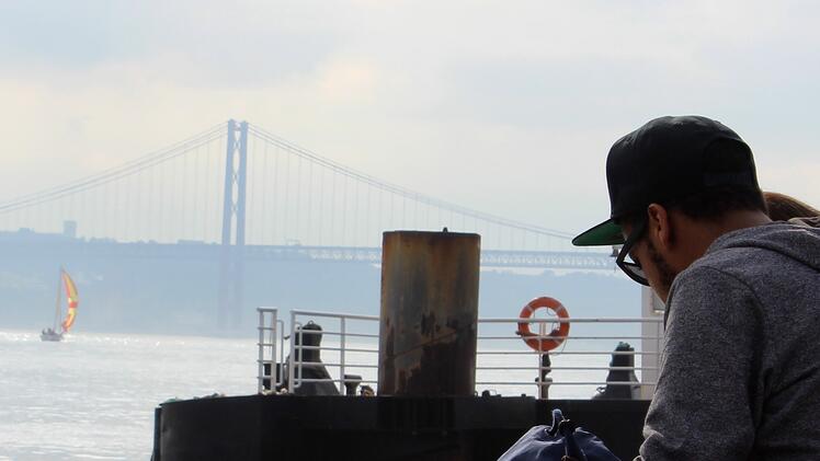 JWU student taking in the view of the Ponte 25 de Abril bridge in Lisbon.
