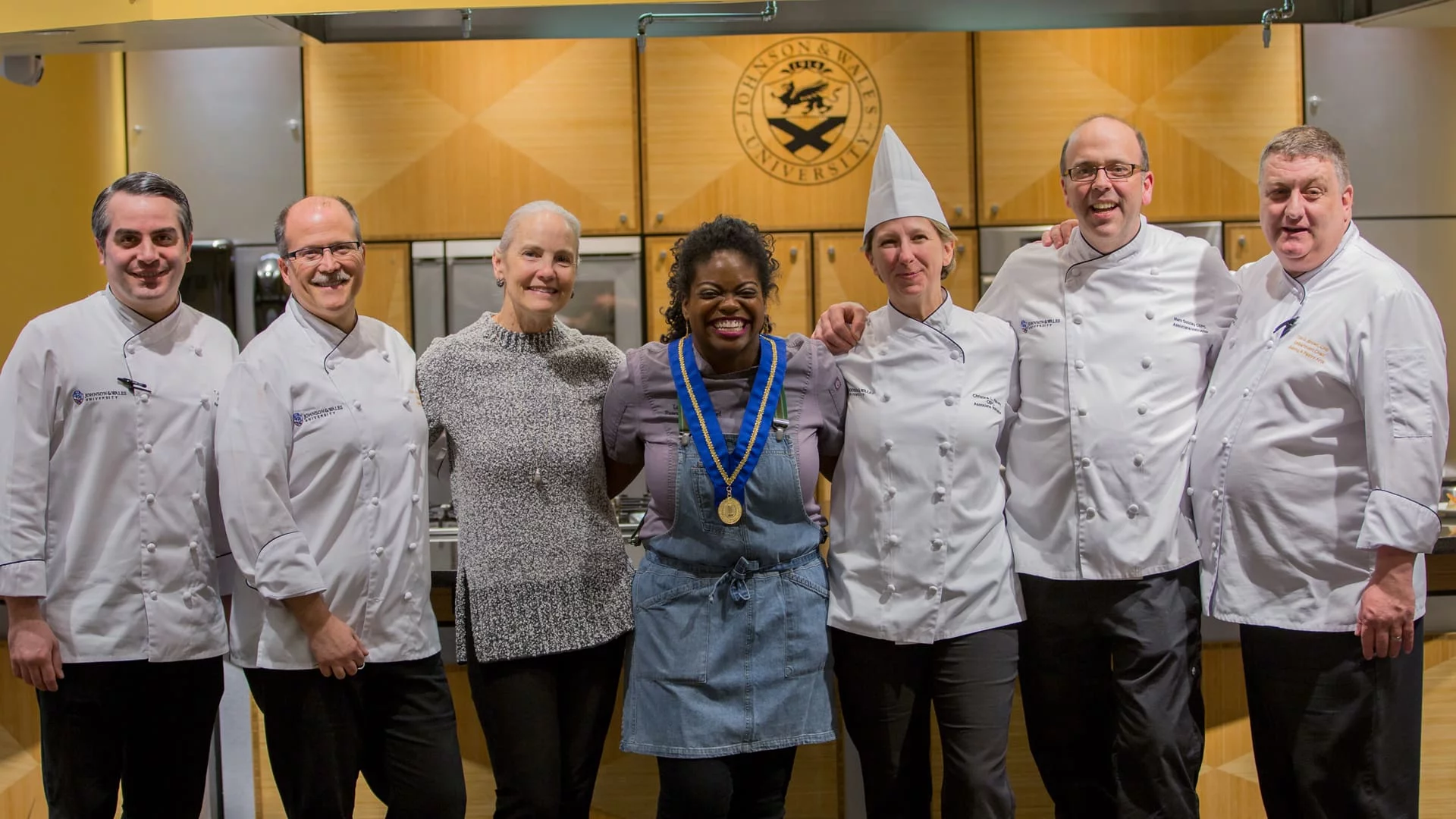 Faculty members smiling in a group with Hotel Atlanta’s Executive Pastry Chef Lasheeda Perry
