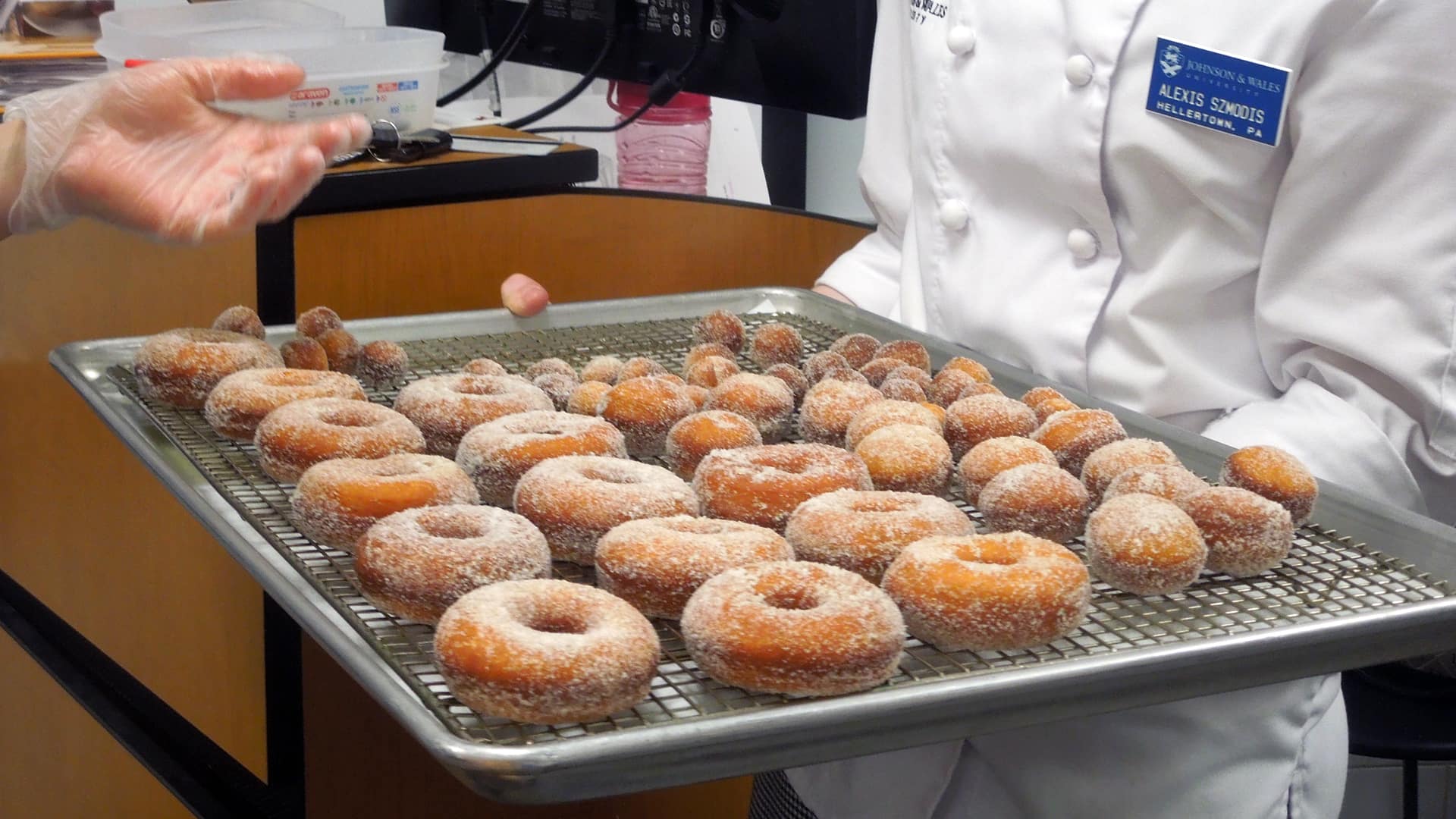 Fresh cooked donuts covered in sugar