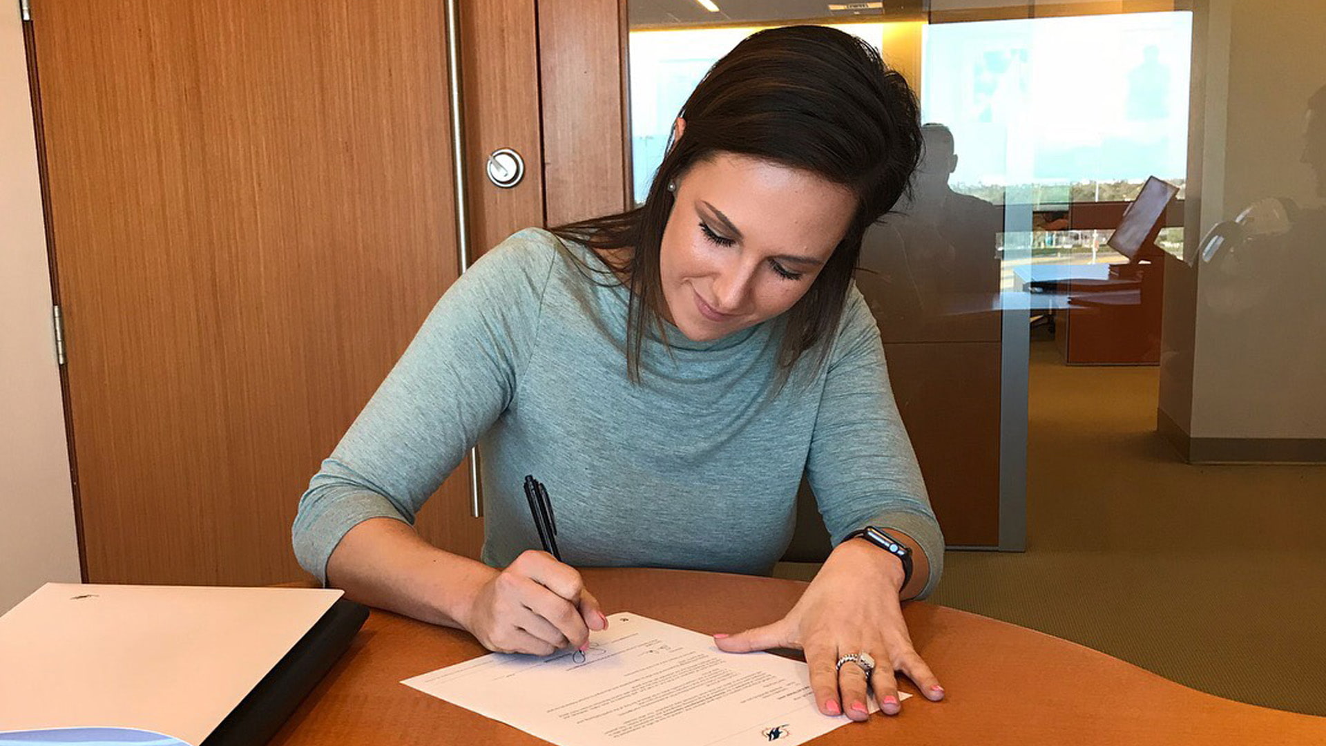 Samantha Creech signs with the Miami Dolphins.