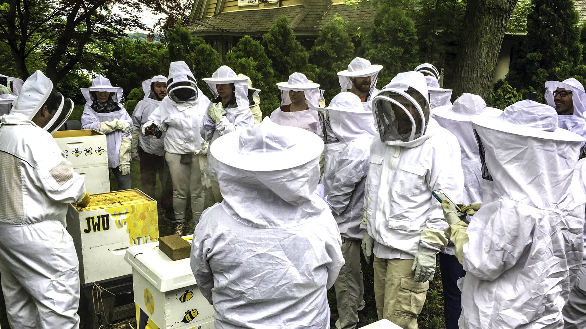 Honey Summit attendees get a tour of JWU's beehives.