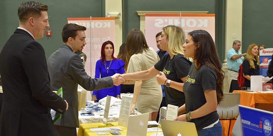 JWU students networking at a Career Fair on campus.