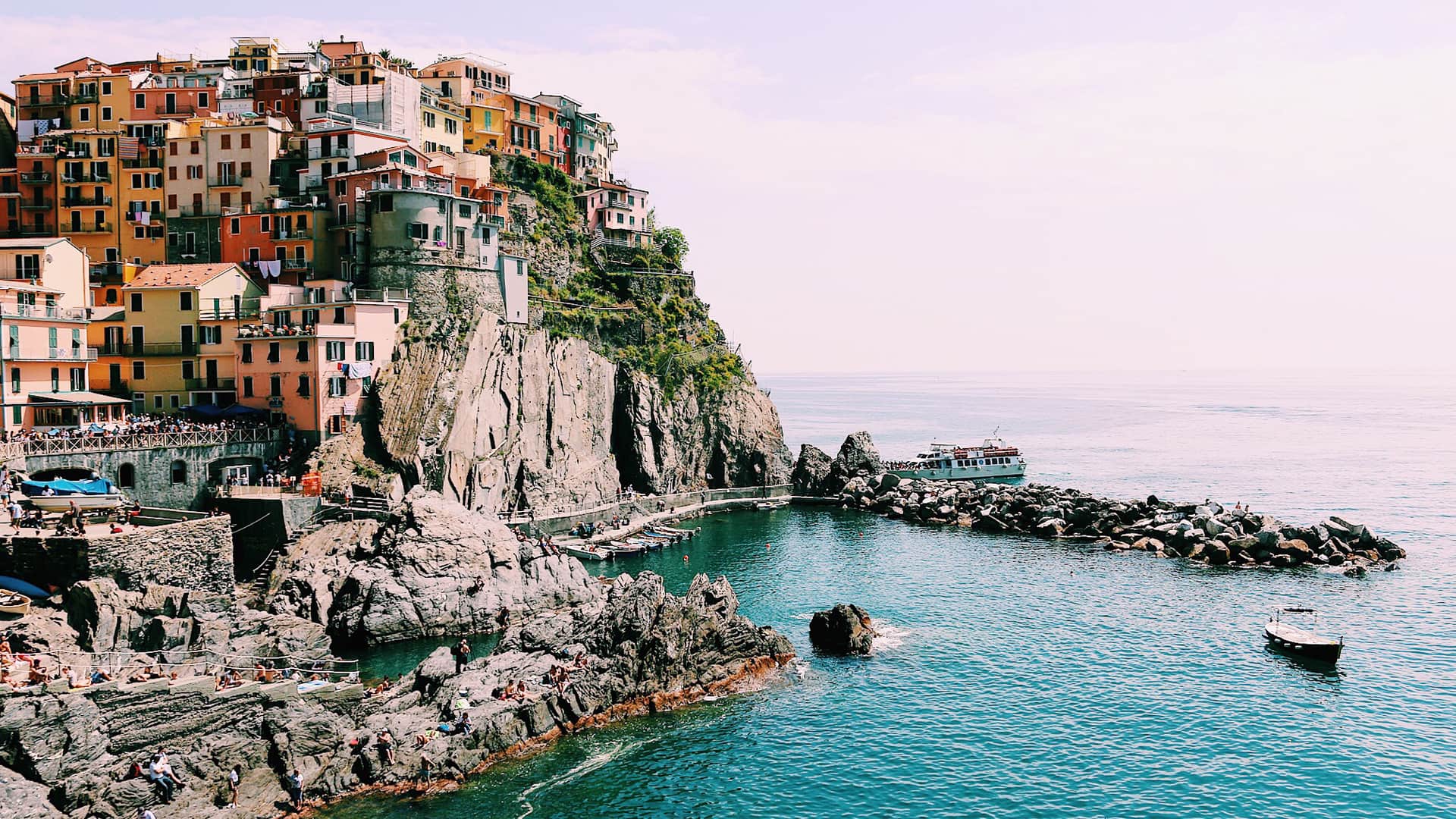 Houses clustered on a steep rocky hill, Cinqueterre, Italy.