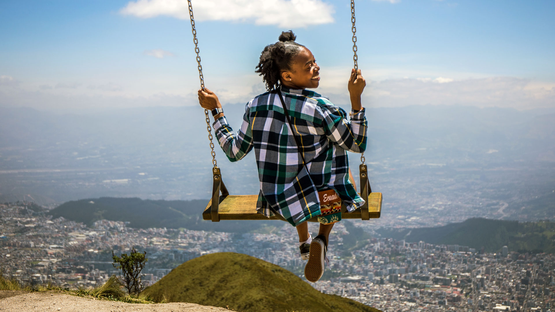 Janet Robinson braves the swing ride overlooking Quito