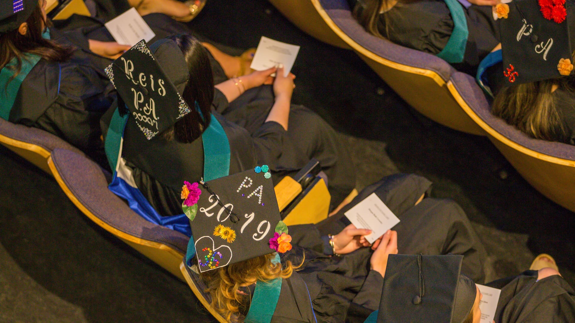 Decorated mortarboards at 2019 JWU PA Studies Commencement.