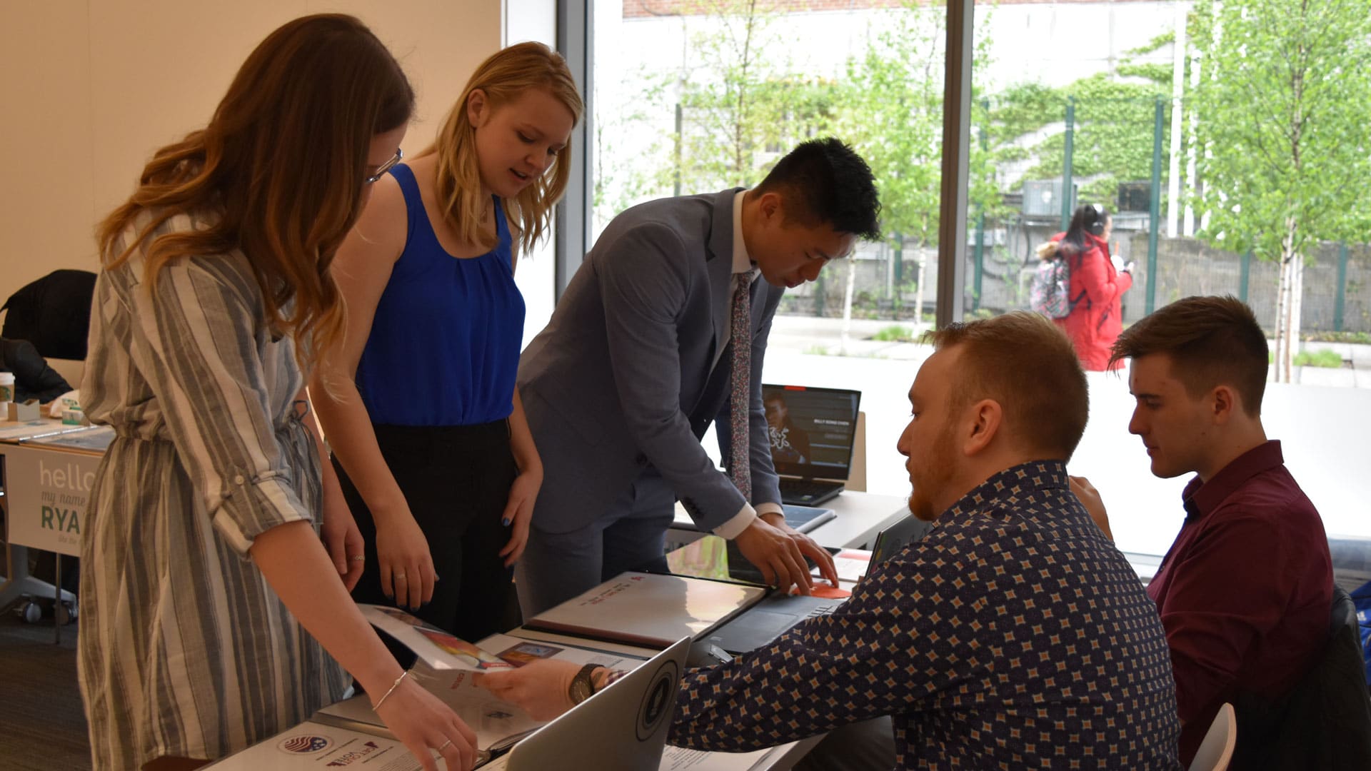 Students show their portfolios at the event.