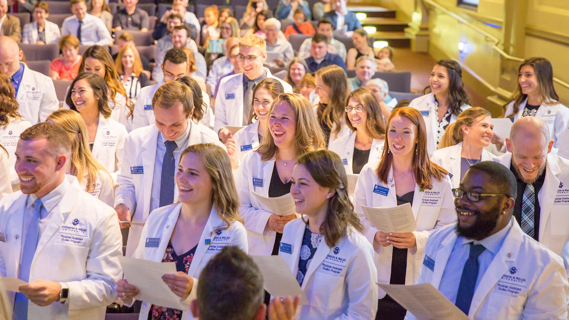 PA students laughing during White Coat ceremony.