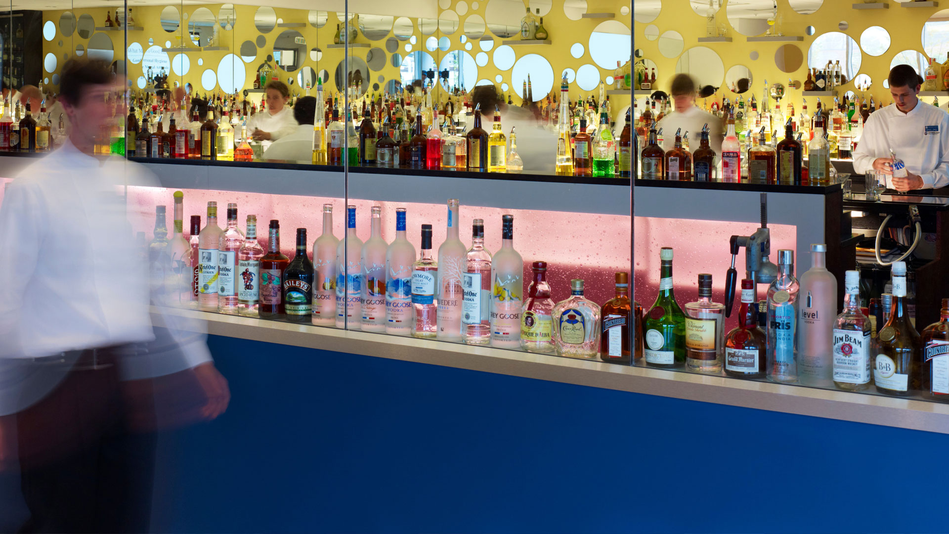 Backlit lab bar with bottles.