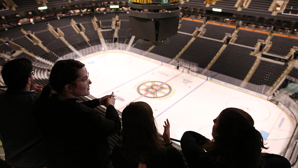 Four students look at TD Garden ice