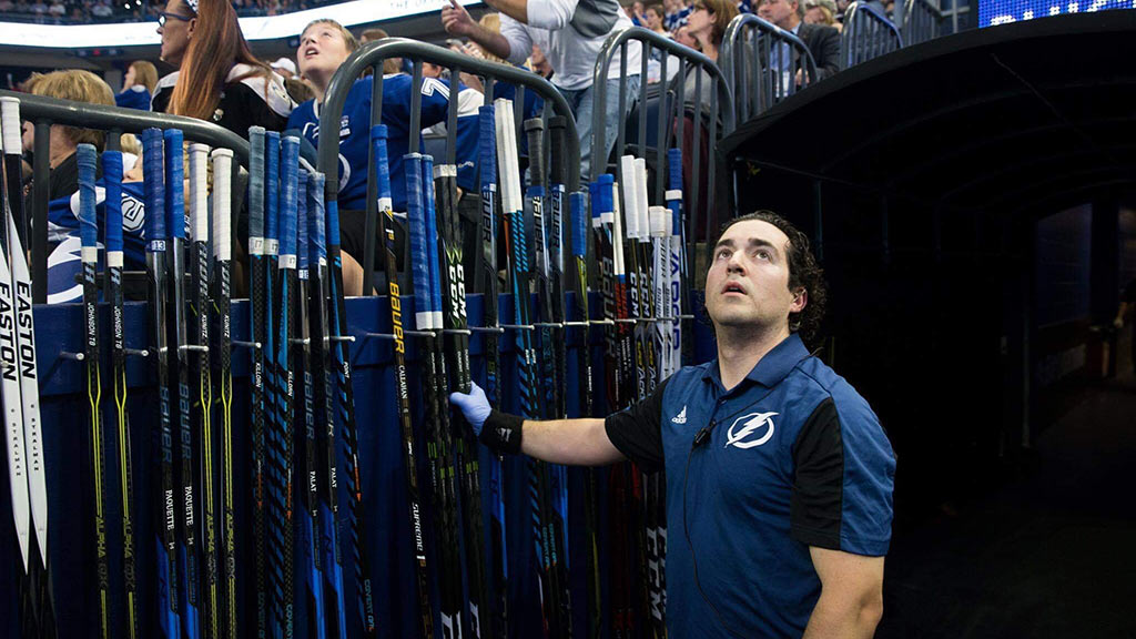 Jason Berger with hockey sticks during a Tampa Bay game