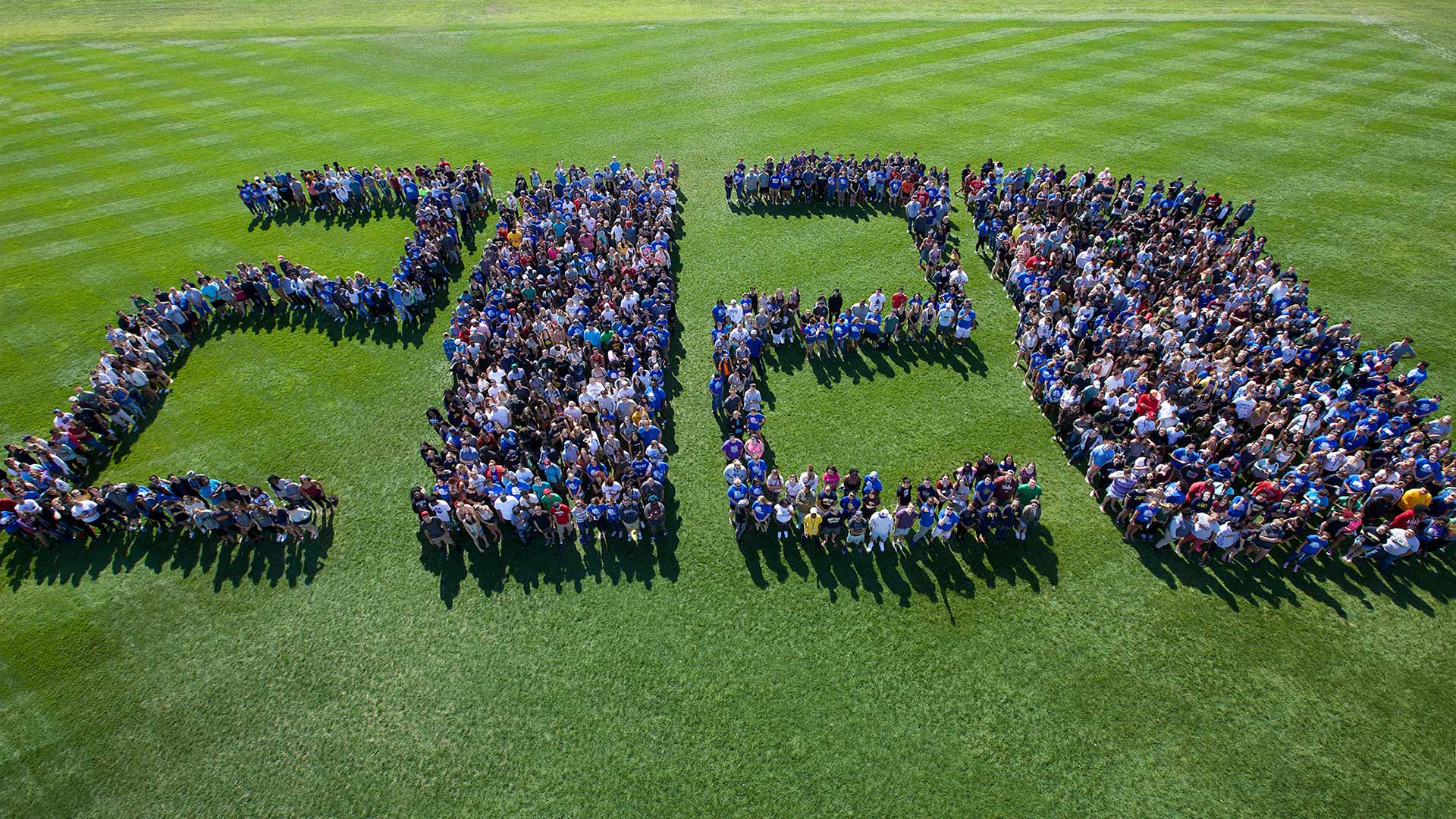 An aerial photo of students standing in the shape of the numbers 2020