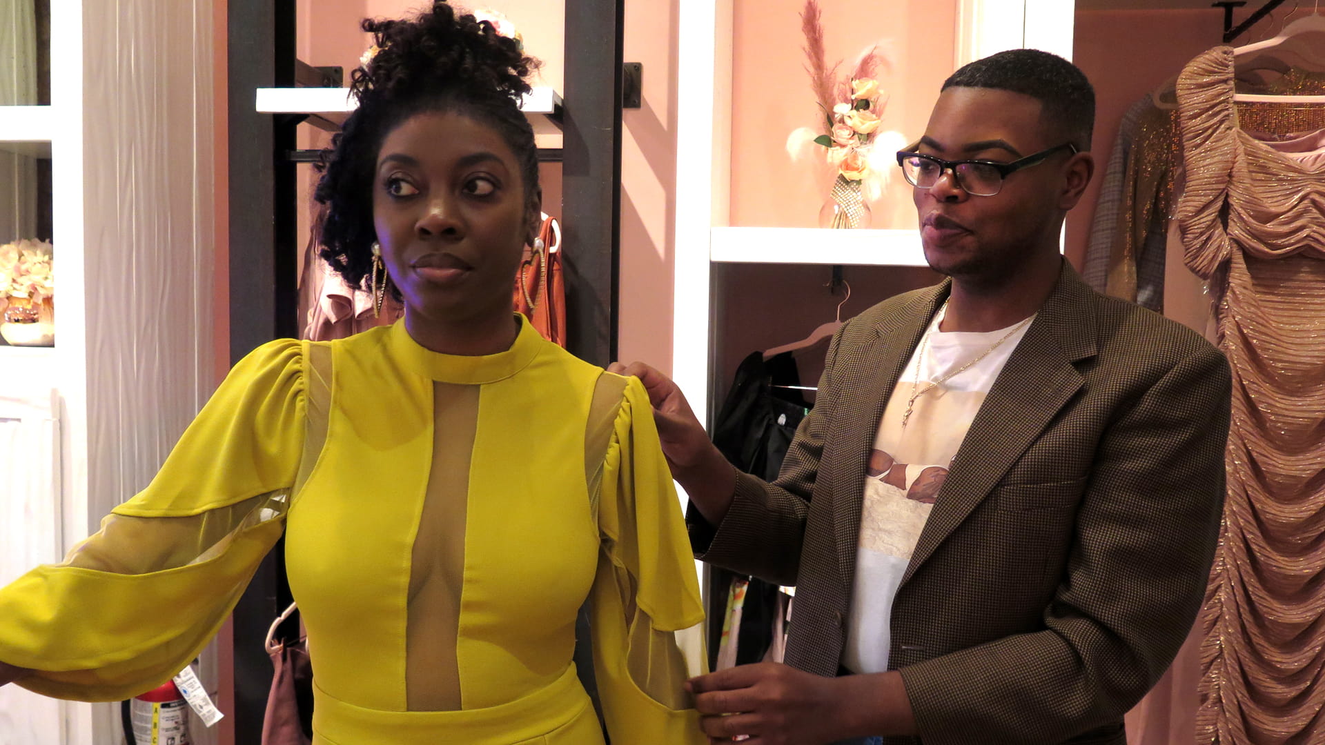 Derrick Tre '17 assists with a dress fitting at Captivate, the boutique where he is a manager.