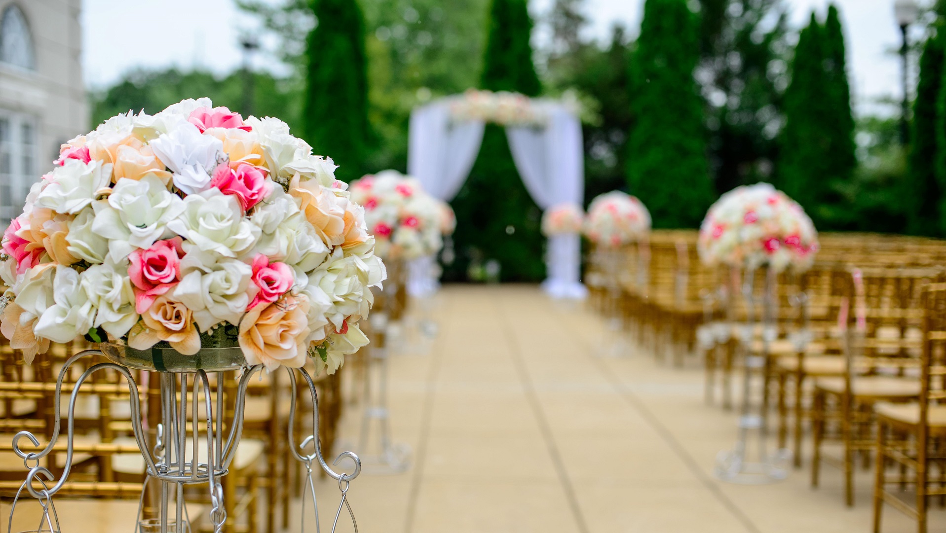 Outdoor wedding with aisle decorated with flowers