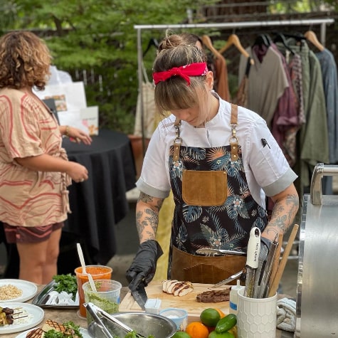 Chef Sky Hanka '15 cooking at an outdoor market event.