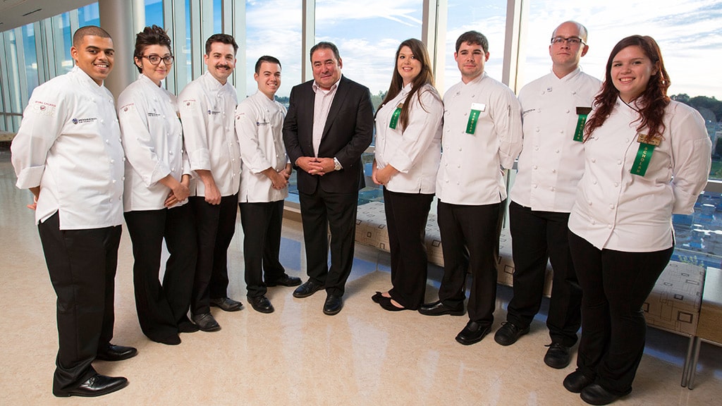 Emeril Lagasse '78, '90 Hon. poses with JWU culinary students
