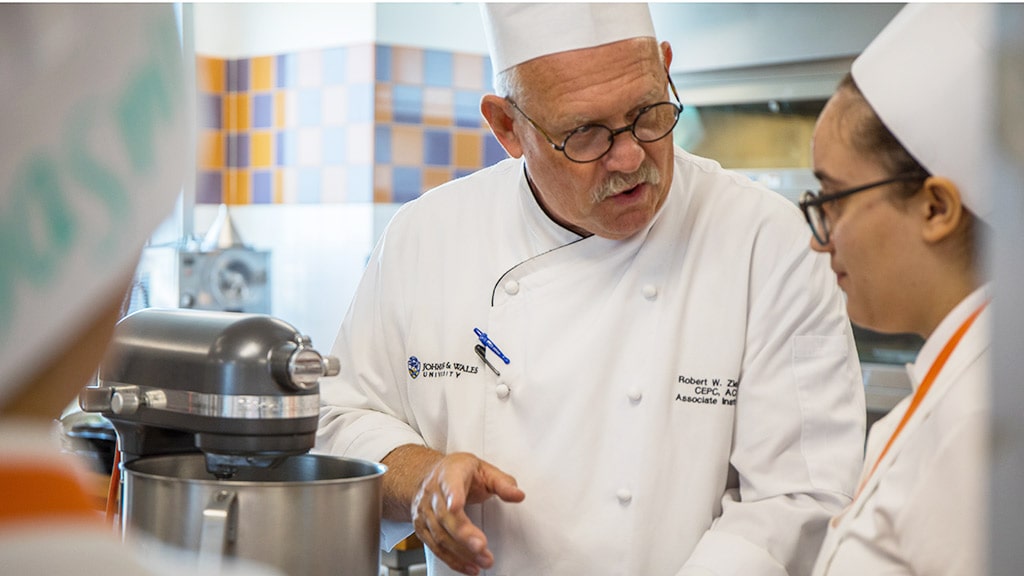 JWU Associate Professor Robert Zielinski works with students on pastry and baking arts