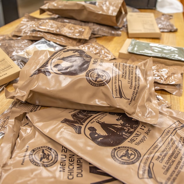 Meal, Ready-to-Eat (MREs) spread out on a table at JWU Providence.