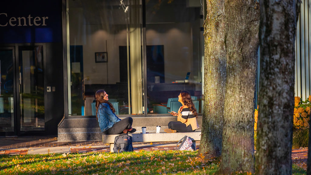 Two students sitting and talking in Gaebe Commons