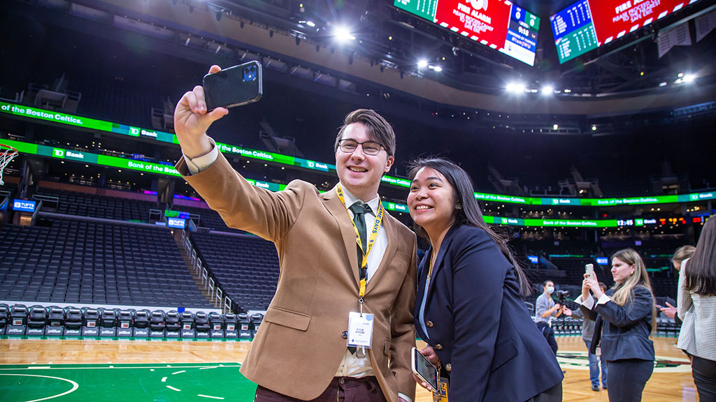 Students taking photos on the court at TD Garden