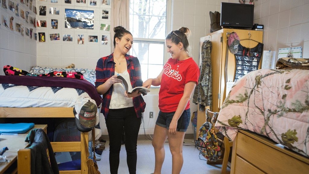 two girls laughing in their dorm