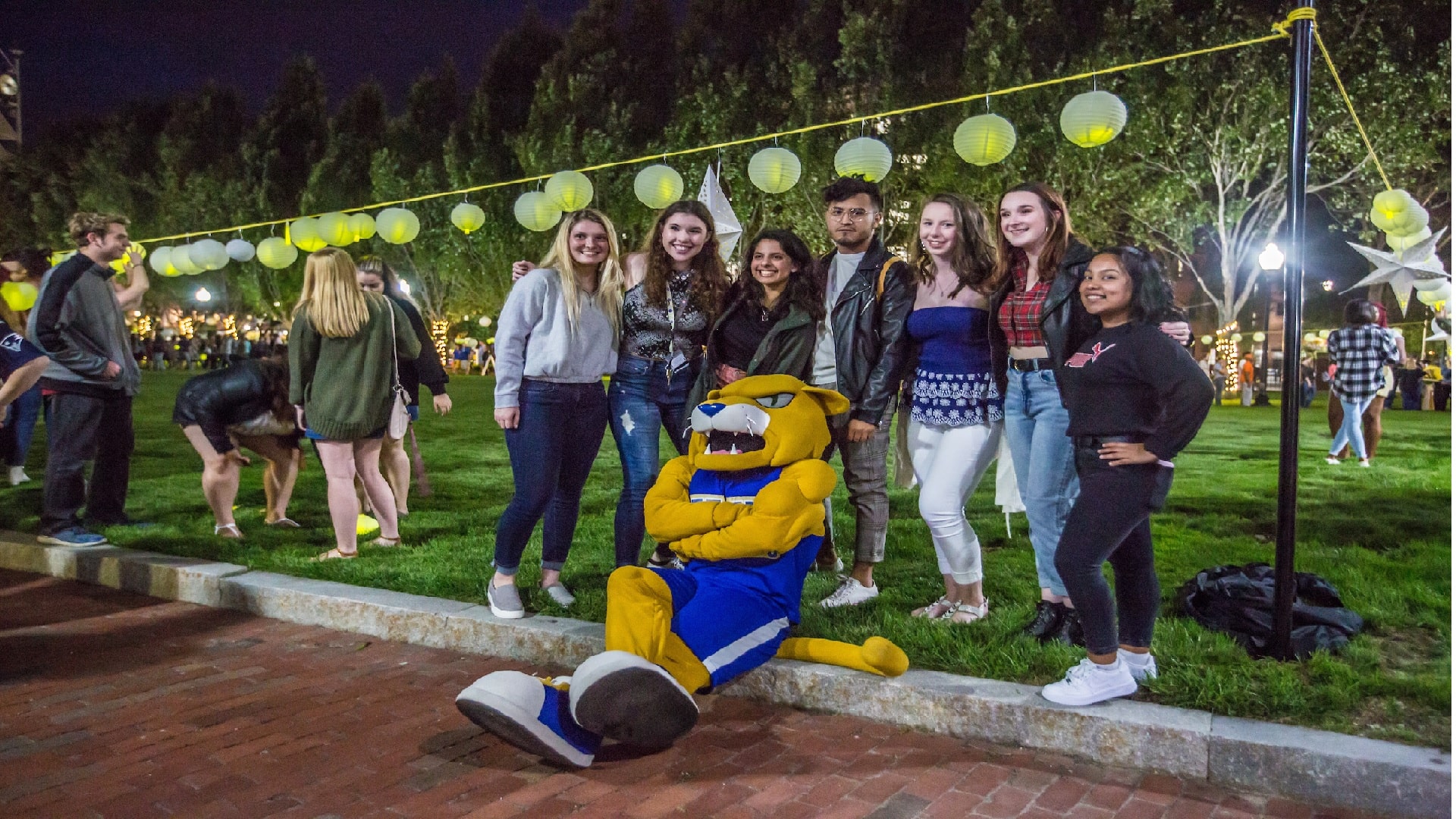 a group picture with students and JWU mascot Willie at Ignite the Night 