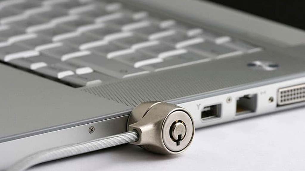 a closeup photo of a safety lock attached to a laptop computer