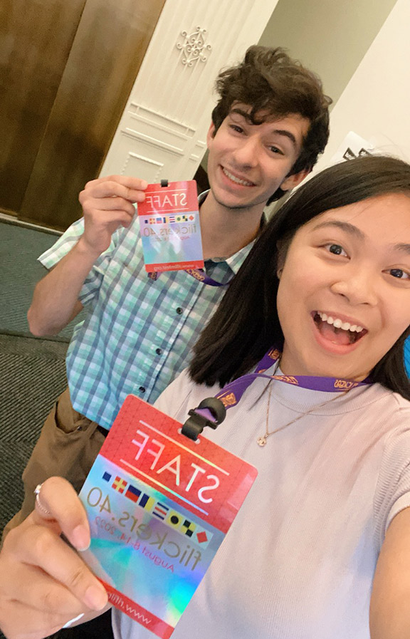Students Trevor Emma and Hilary Thilavong holding up their RIIFF staff badges at their summer internship.