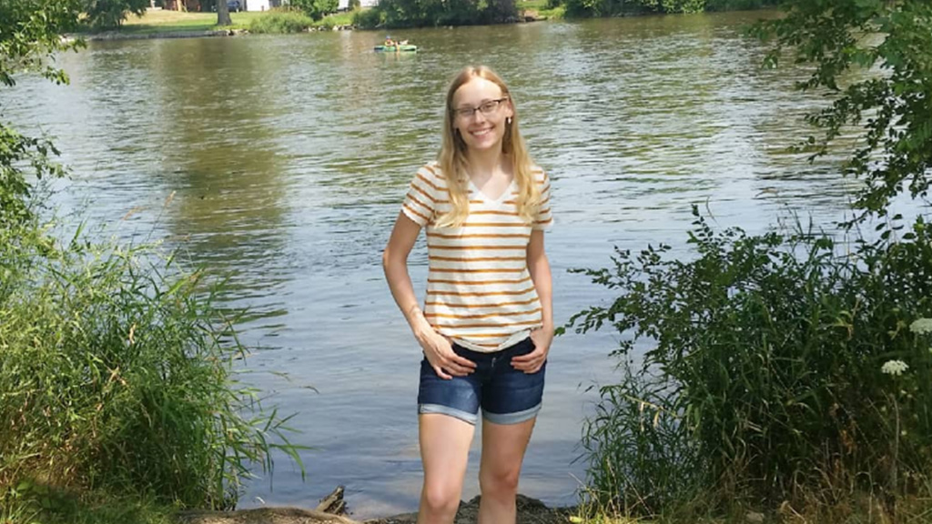 Student Sasha Joseph standing in front of a lake.