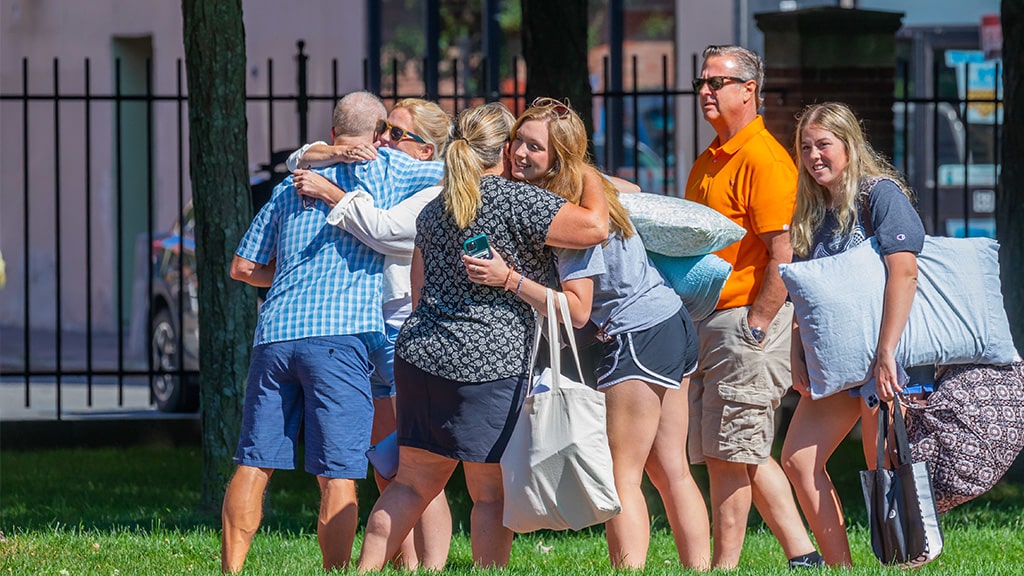 college student hugs family at move-in
