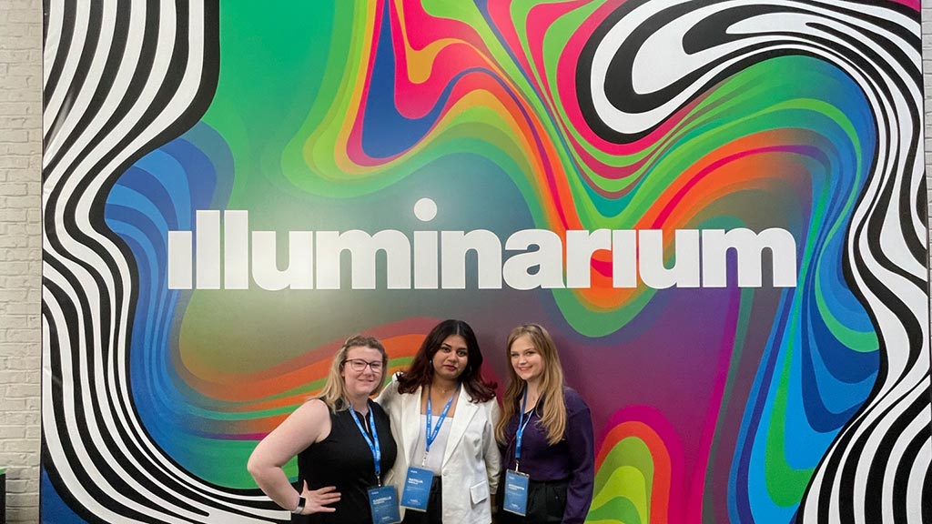 JWU DECA chapter students pose for a photo at the colorful Illuminarium in Atlanta, Georgia