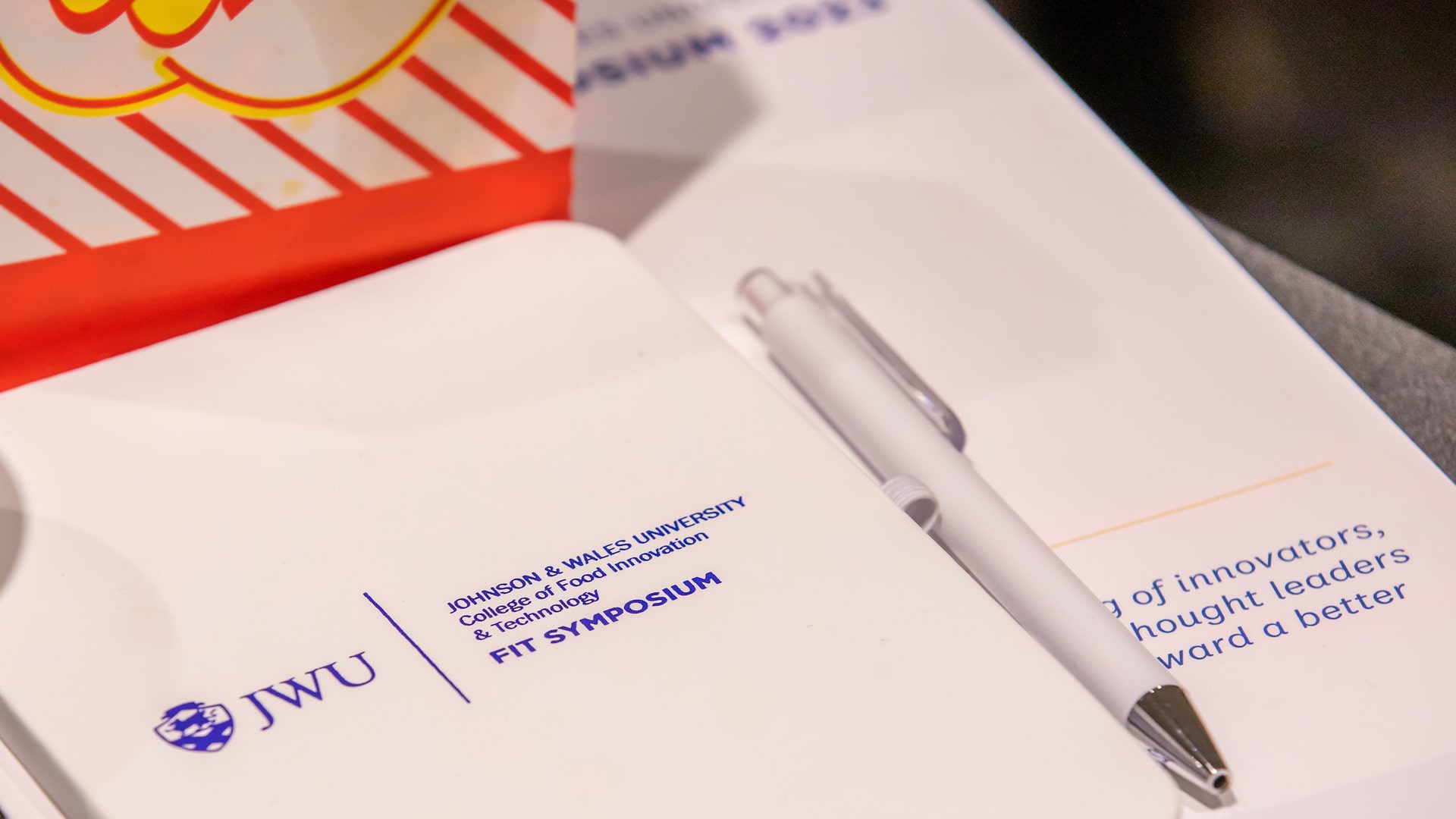 Notebooks, stationery and pens branded with the logo of JWU Providence’s 2023 FIT Symposium.