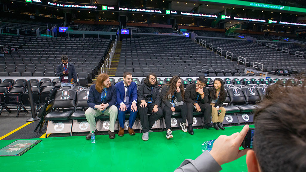 Students sitting the Celtics players seats at TD Garden