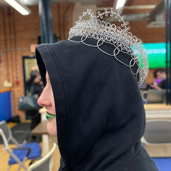 A student with a handmade metal crown on their head