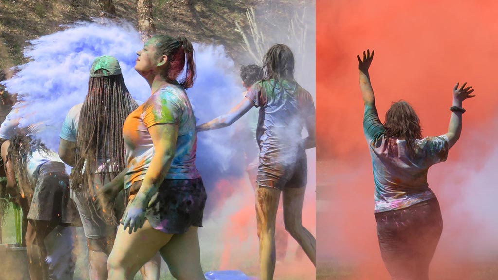 students using colorful chalk dust at Holi