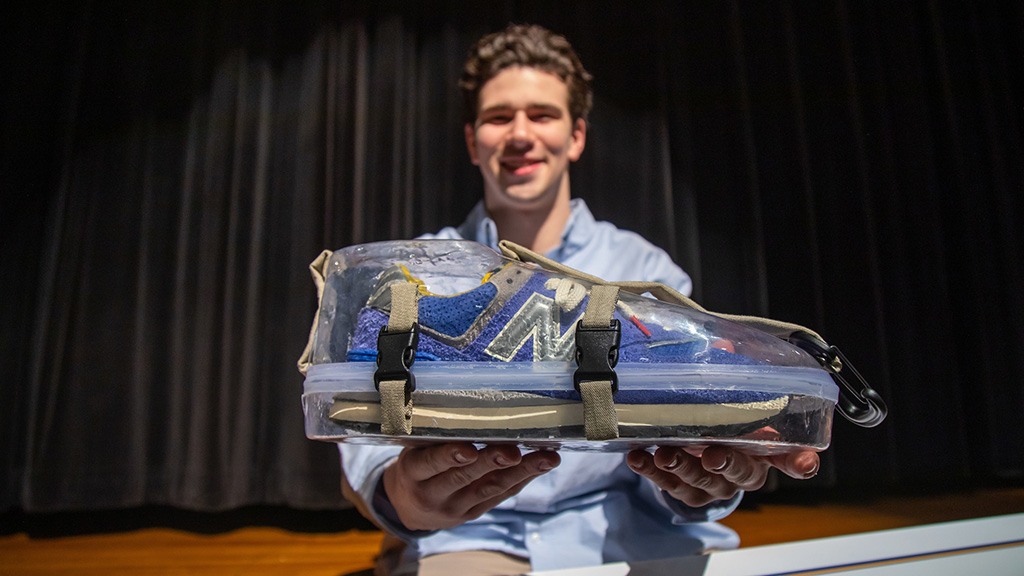 Sawyer Cosgrove '23 holding his prototype for Lace Case, a plastic case to protect shoes