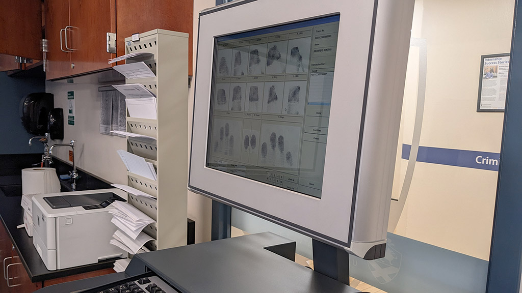a photo of a computer screen showing scanned images of fingerprints